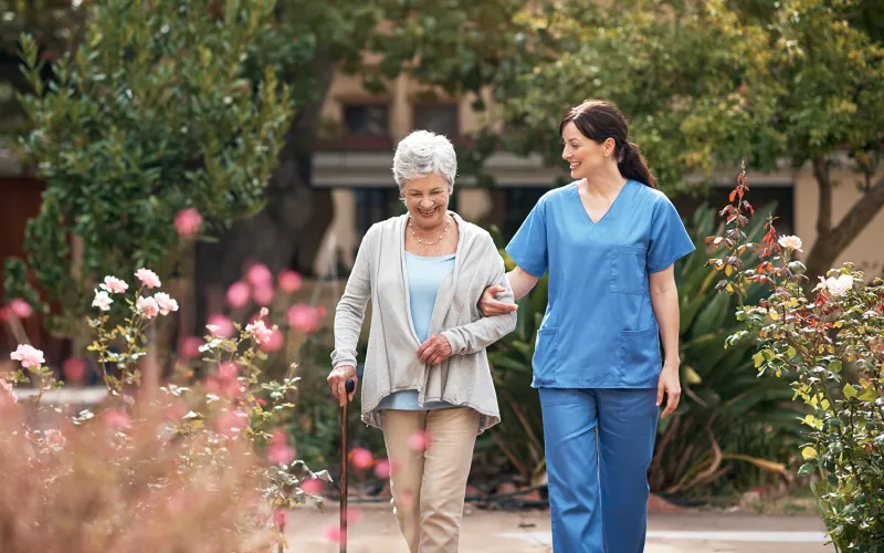 Caregiver and lady walking