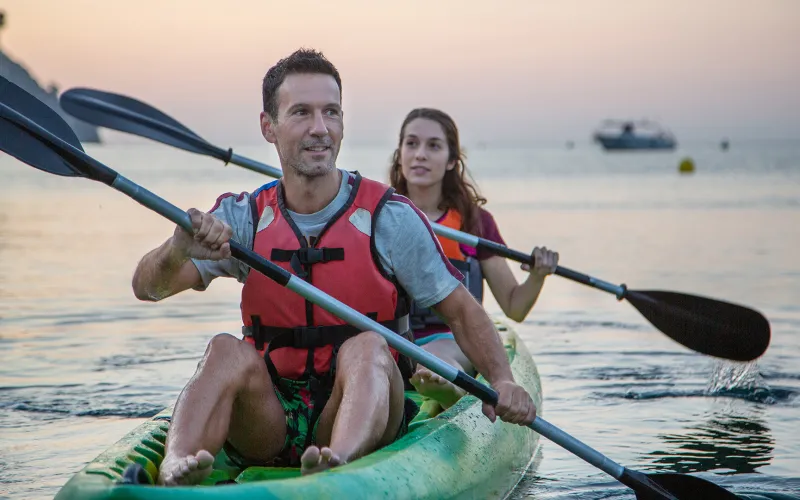 Young couple kayaking on the ocean