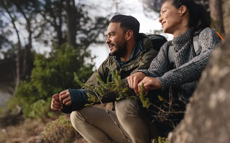 Couple hiking sitting on rock