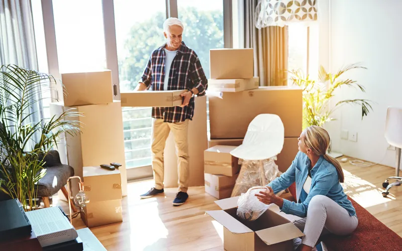 Older couple packing moving boxes