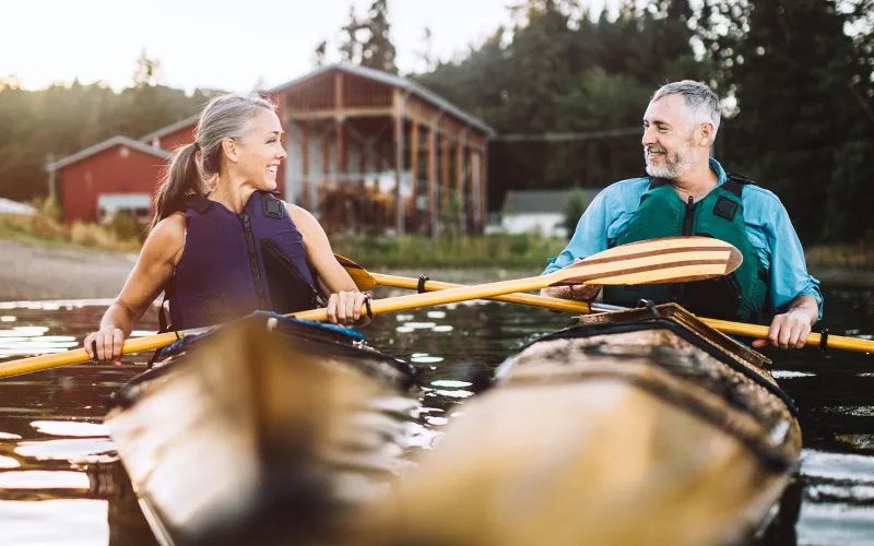 Couple paddling in kayaks 