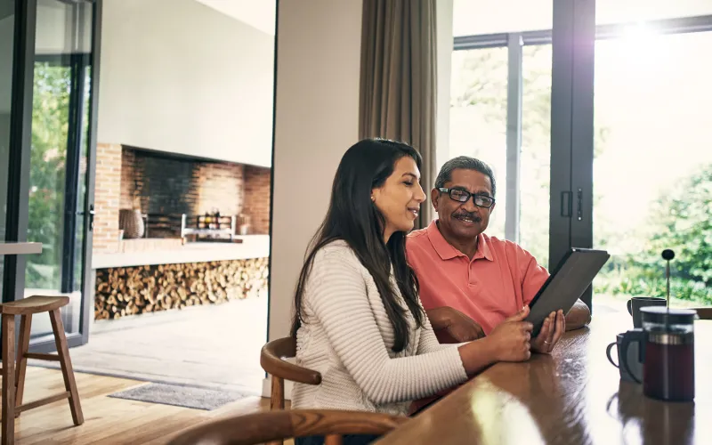 Couple in home researching on tablet