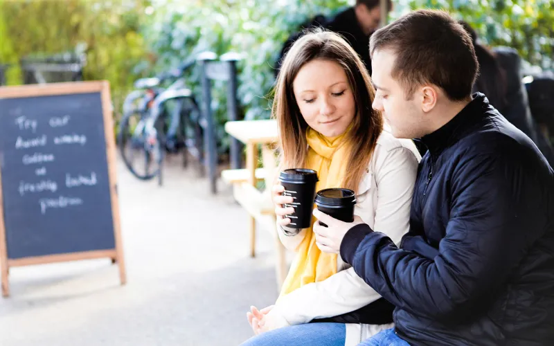 Couple talking about finances over coffee