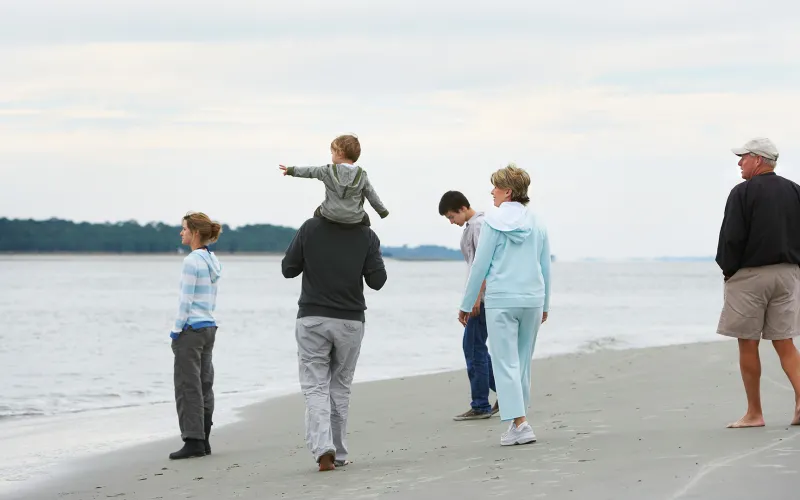 Extended family walking along the beach