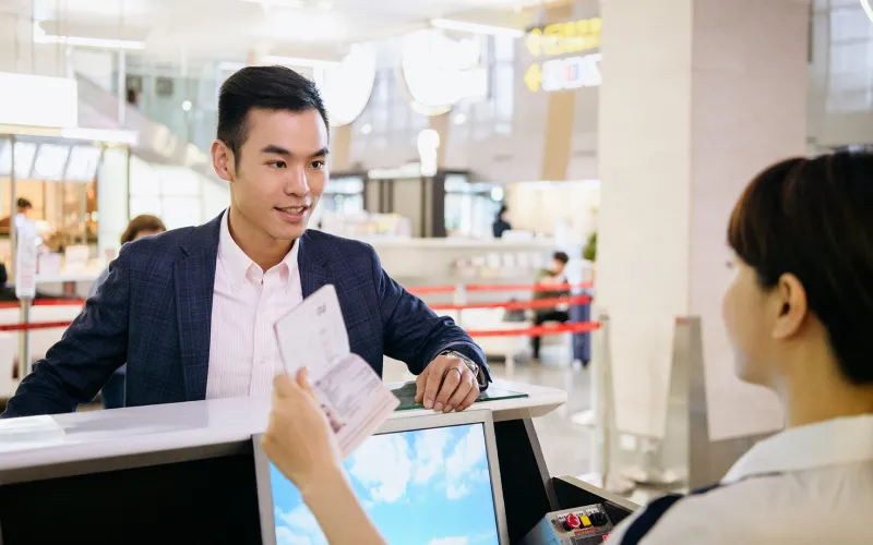 Woman checking ID of traveler