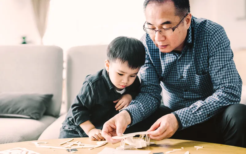 Grandfather and grandson playing together