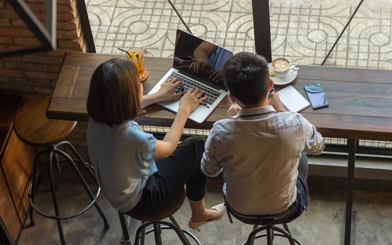 Couple investing using their laptop