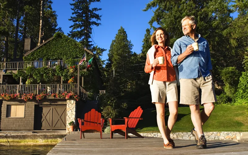 Older couple enjoying coffee outside their home 