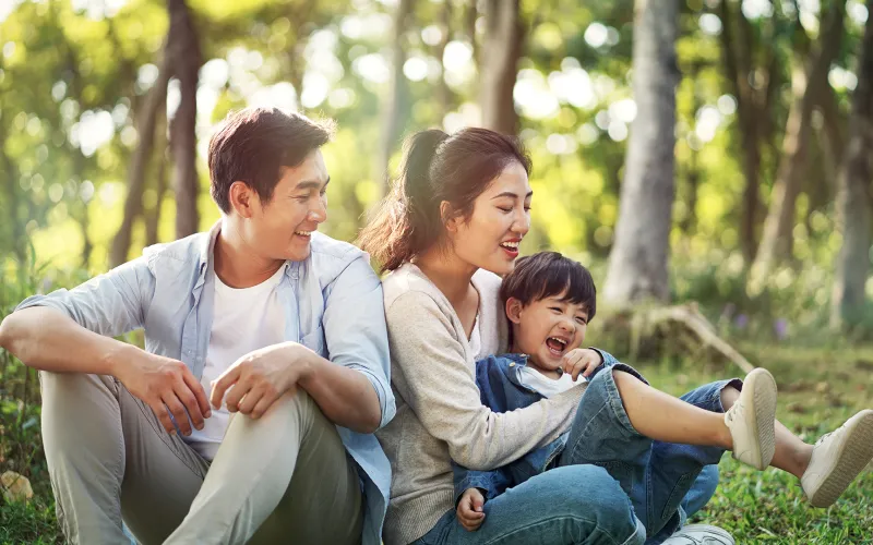 Family sitting outside in a forest