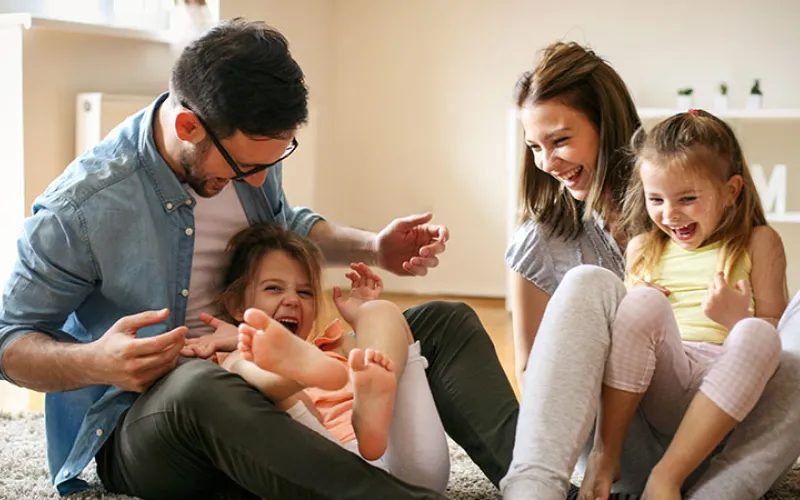 Family laughing at home
