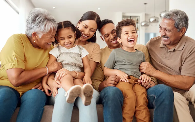 Extended family laughing on the couch