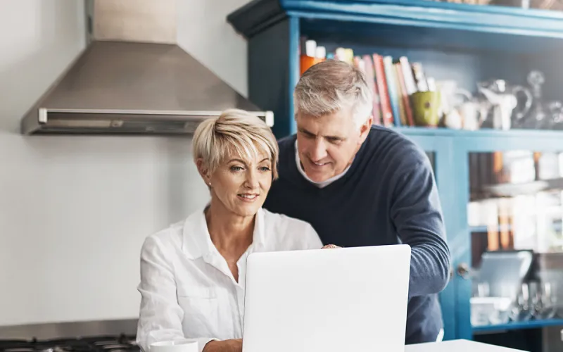 Man and woman looking at laptop.