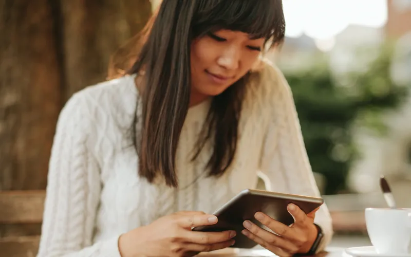 Woman looking at tablet.