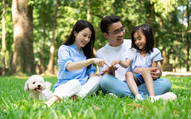 A family and their dog playing together