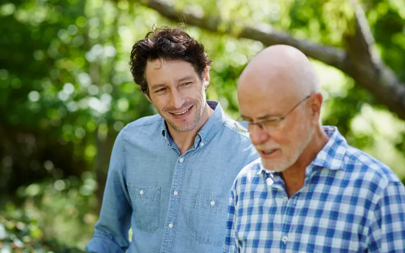 A Father an son chatting to each other while taking a walk