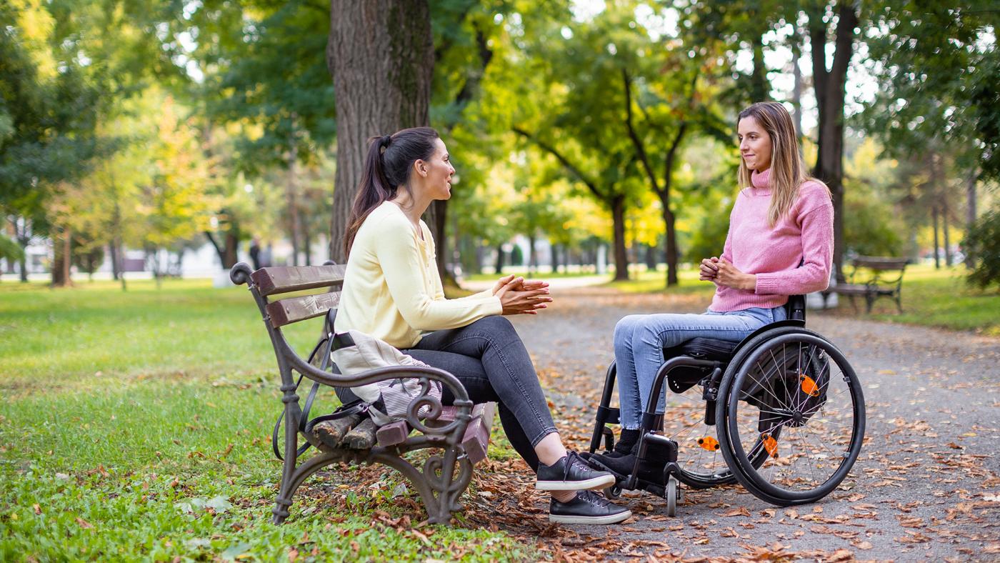 Lady in wheelchair talking with a friend