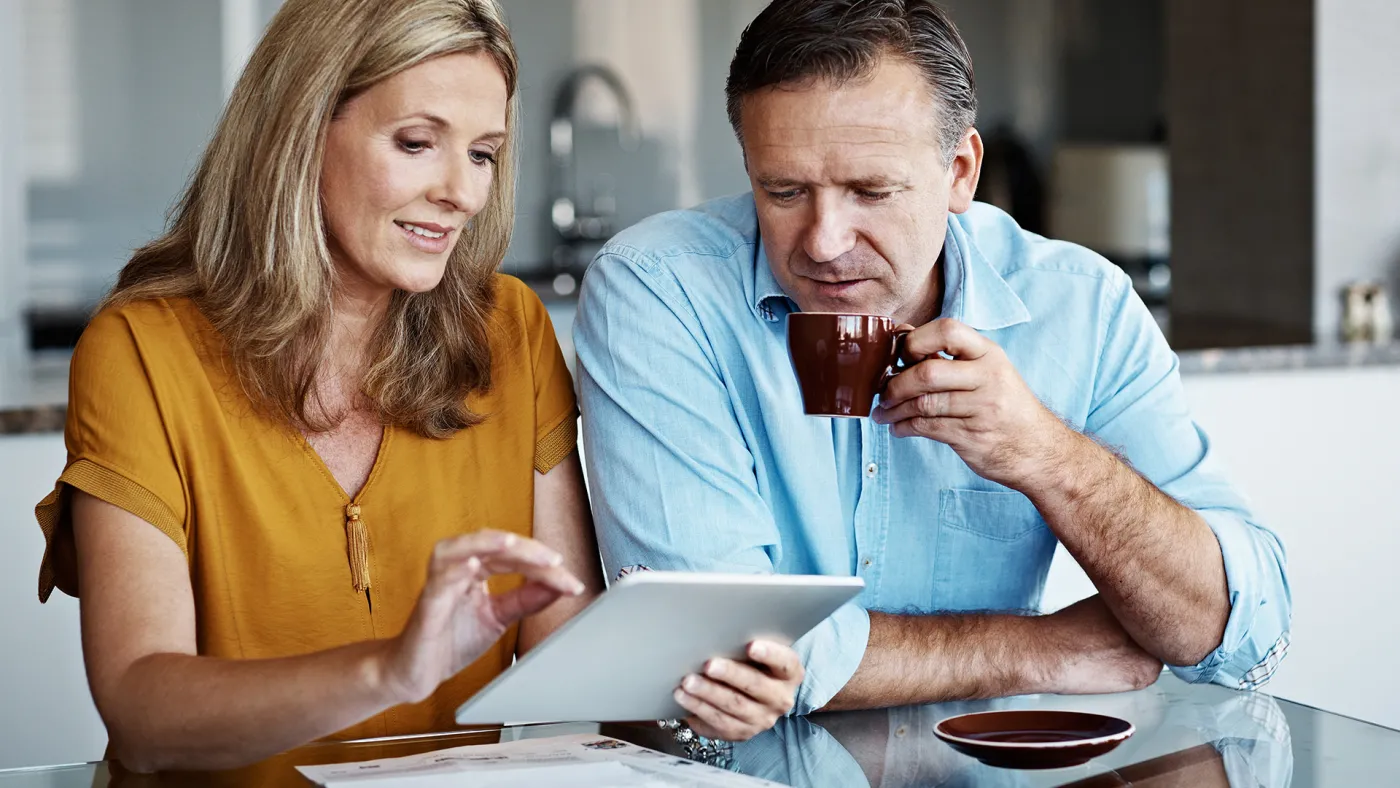 Couple making retirement plans using tablet