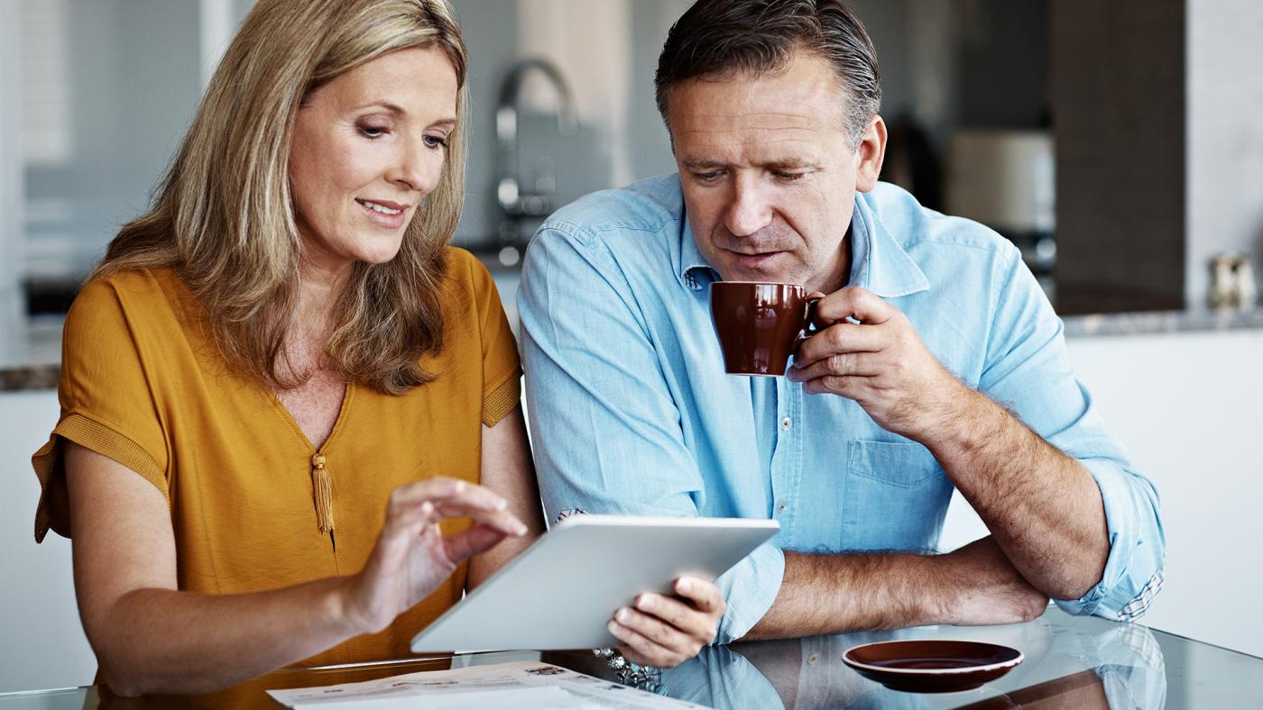Couple making retirement plans using tablet