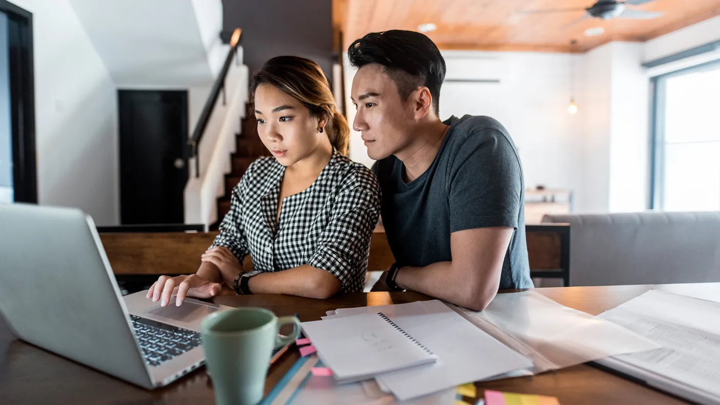 Couple working on their financial plan on a computer