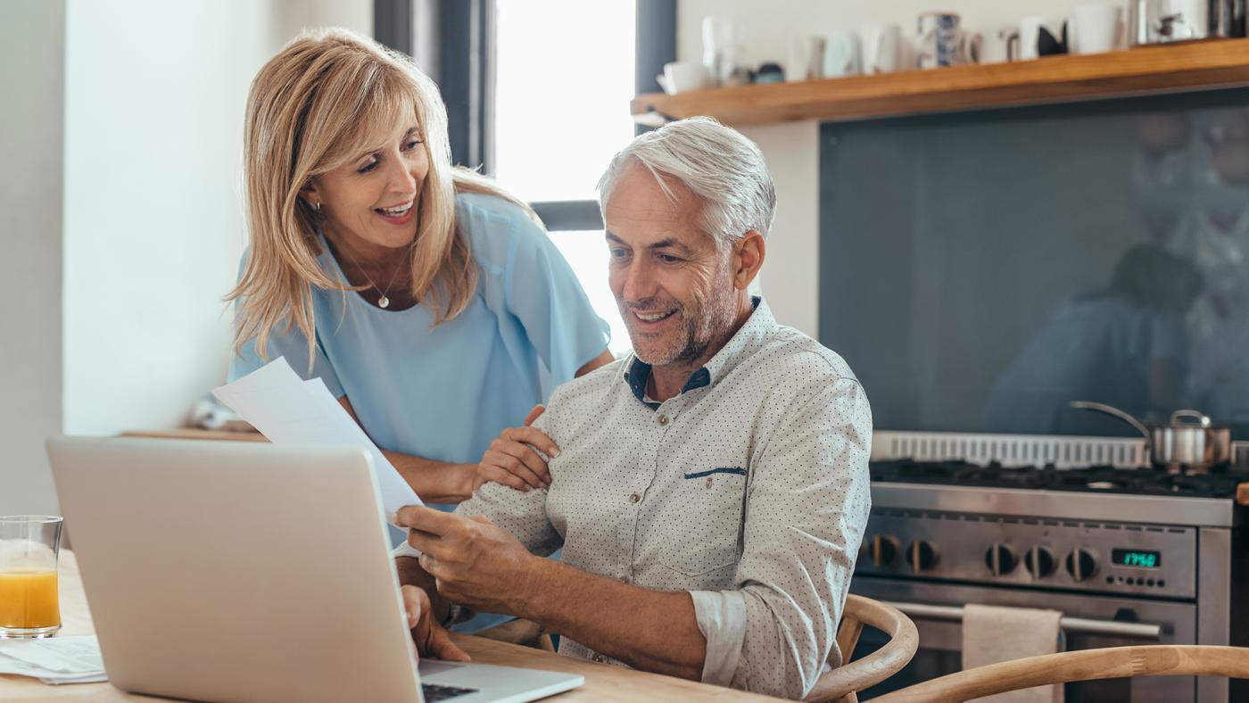 Older couple planning in front of computer