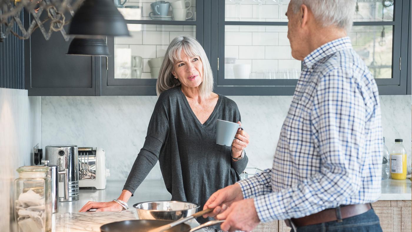 Older couple talking in kitchen