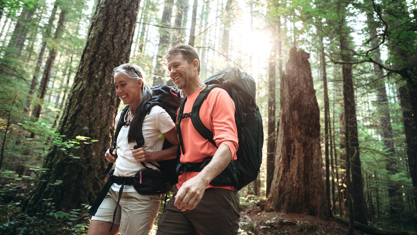 Middle-aged couple hiking in a forest