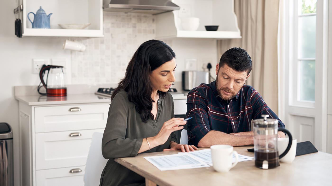 Couple doing financial planning in a kitchen