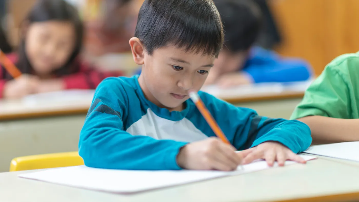Young student writing an essay