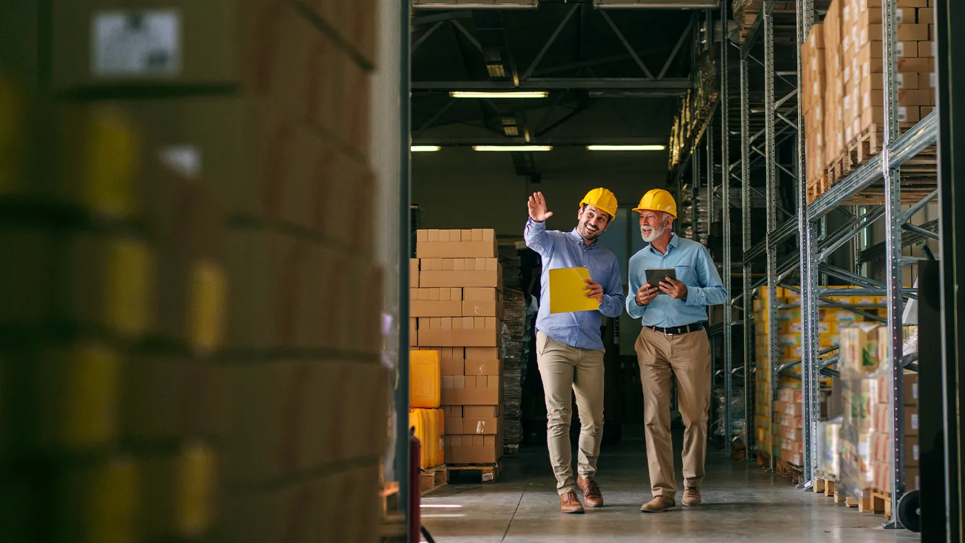 Two men talking in warehouse