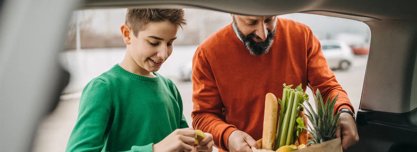 Dad and son packing groceries