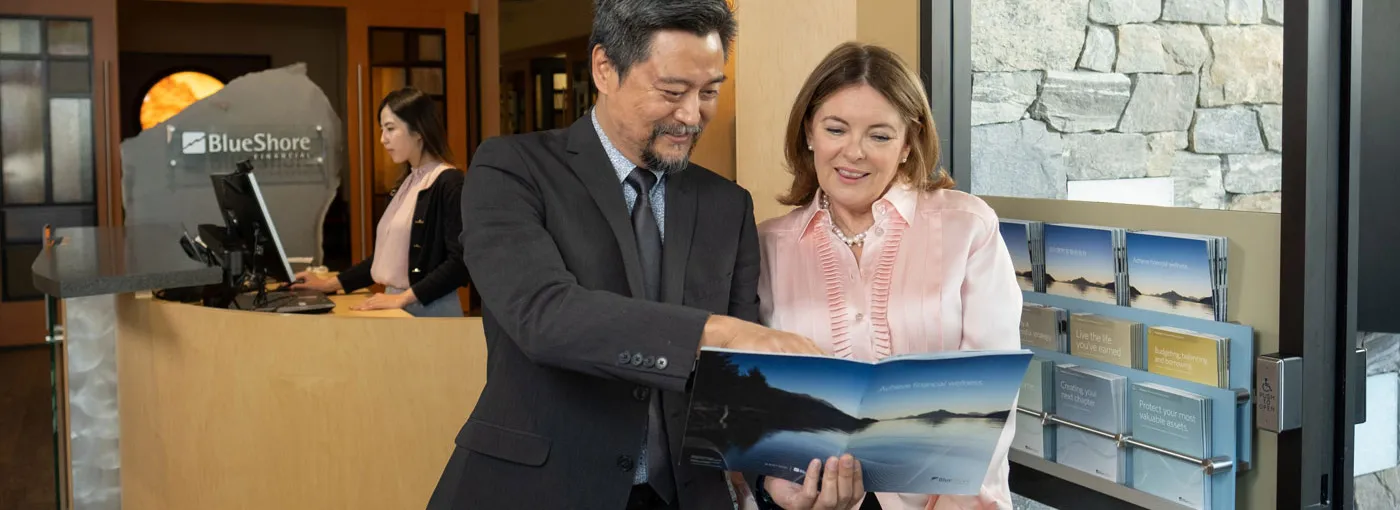 An advisor showing a client some information in a BlueShore branch