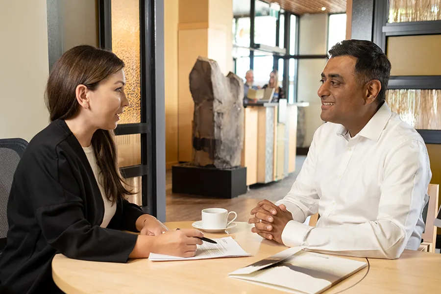 A financial advisor meeting with a client in a BlueShore Financial branch. 