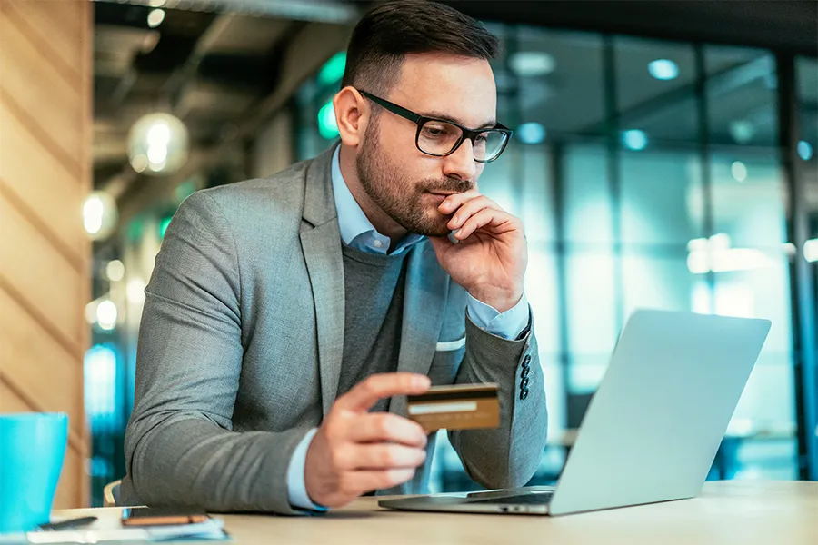 A man looking at his business credit card