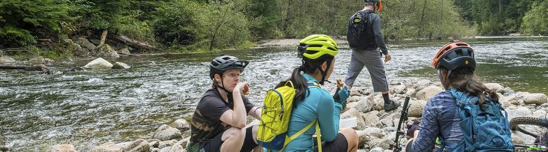 Cyclists taking a break by river