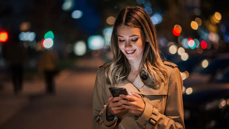 Woman checking investments on her phone