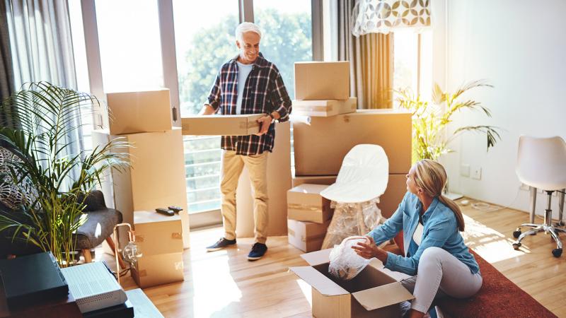 Older couple packing moving boxes