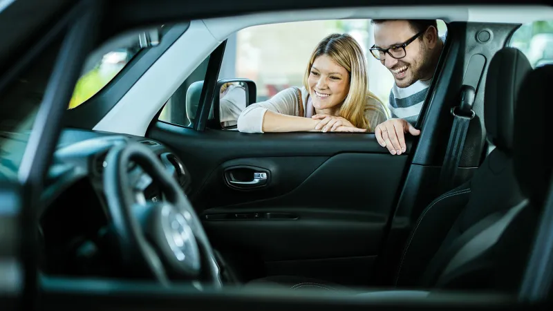 Couple looking at new car