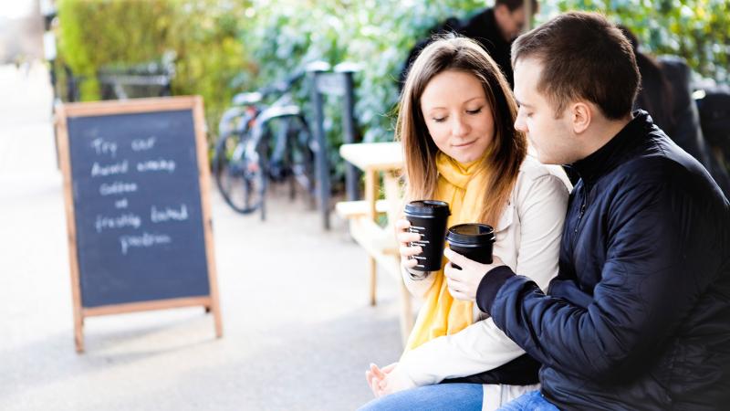 Couple talking about finances over coffee