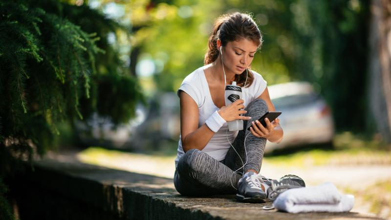 Woman on smartphone sitting on bench