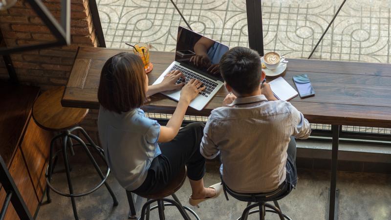 Couple investing using their laptop