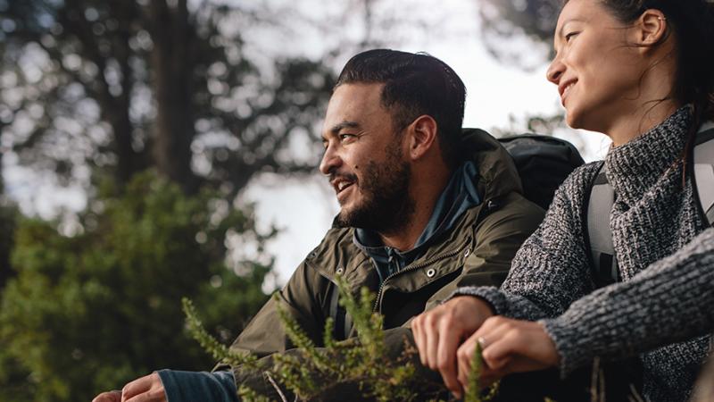 Couple sitting in wooded area