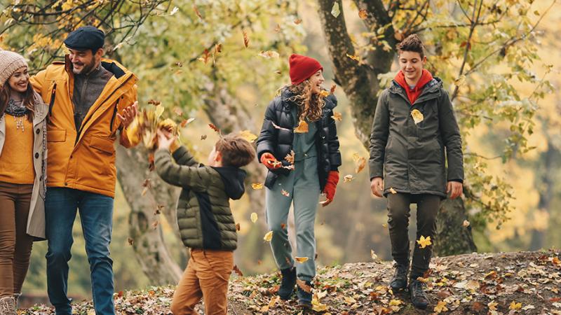 Family out for a walk in Fall in a forest