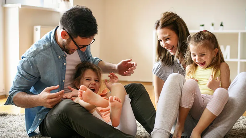 Family laughing at home