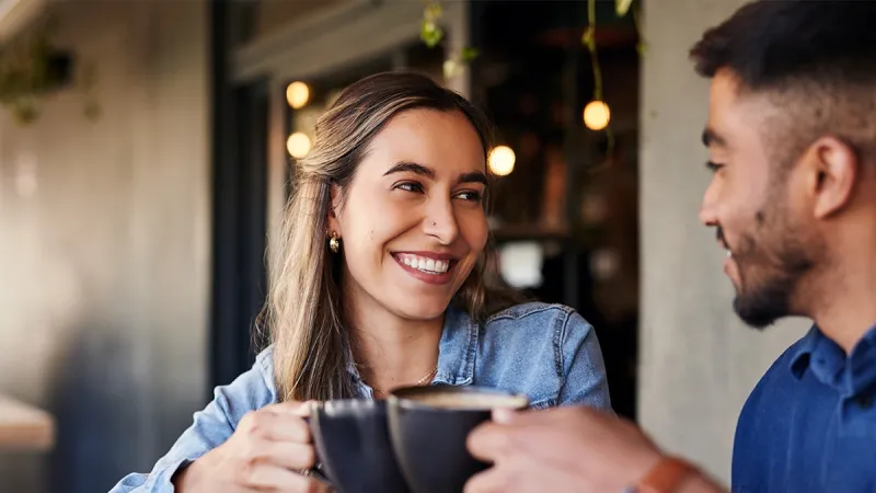 A man and woman having a coffee together in a cafe. 